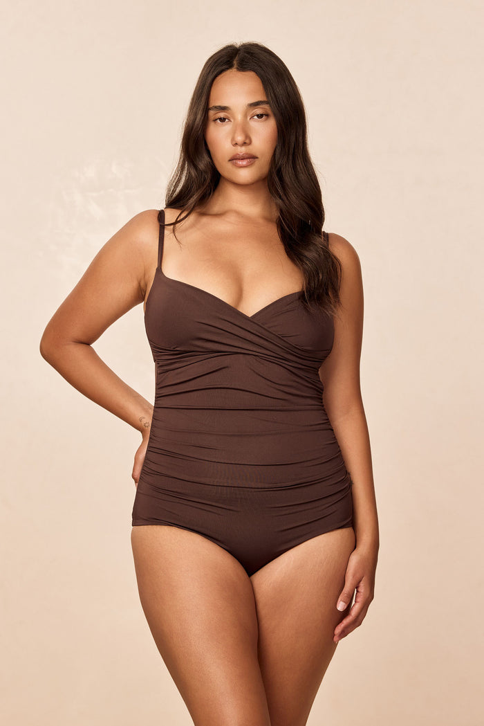 Front view of Bordeaux one-piece swimsuit in Espresso with crossover neckline, adjustable straps and ruched torso