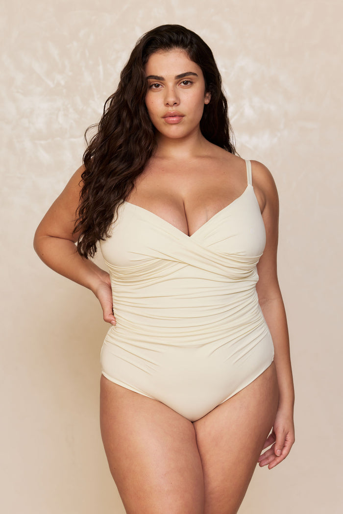 Front of Bordeaux One Piece in Ivory showing ruched bodice, sweetheart neckline and adjustable thin straps on plus-size model