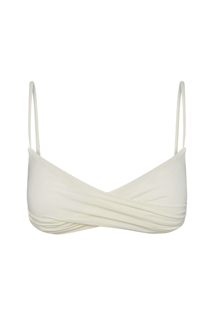 Close-up front view of Bordeaux Top in ivory showcasing wrap-front twist, thin adjustable spaghetti straps and fitted underband on white background