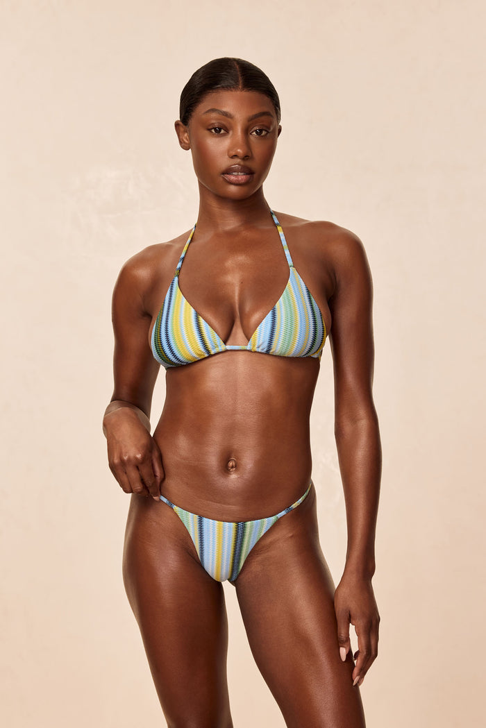 Front view of Brazil Thong, Sardinia Stripe Azure, showing minimal thong coverage and thin side straps on model