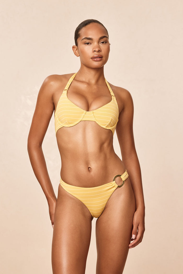 Front of Bronte Bottom in Meyer Stripe showing gold ring hip detail, high cut leg and cheeky mid rise on beige background