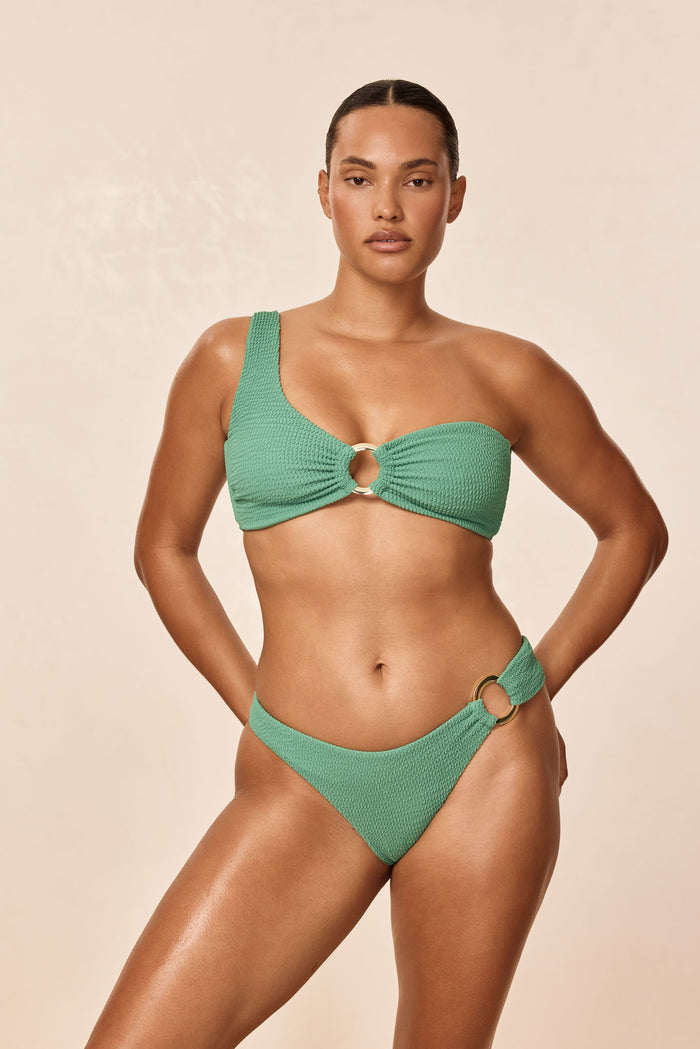 Front view of Bronte Bottom in Pond Crinkle textured fabric with gold ring hip detail on neutral beige background