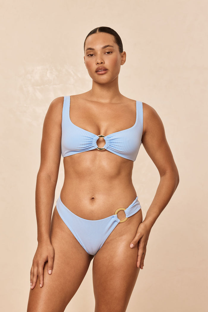 Front of Barbuda Top in Sky Rib showcasing square neckline, wide straps, ribbed fabric and gold ring on neutral background