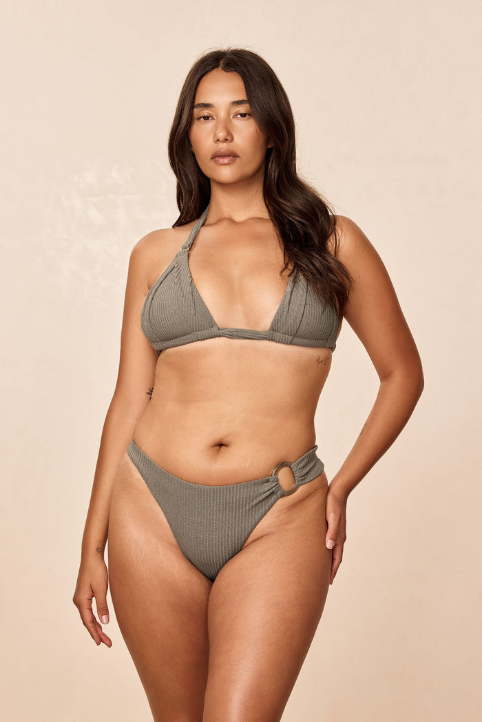 Front view of Bronte bottom in Steel Lurex Rib showcasing ribbed texture and side ring detail on model against a beige background
