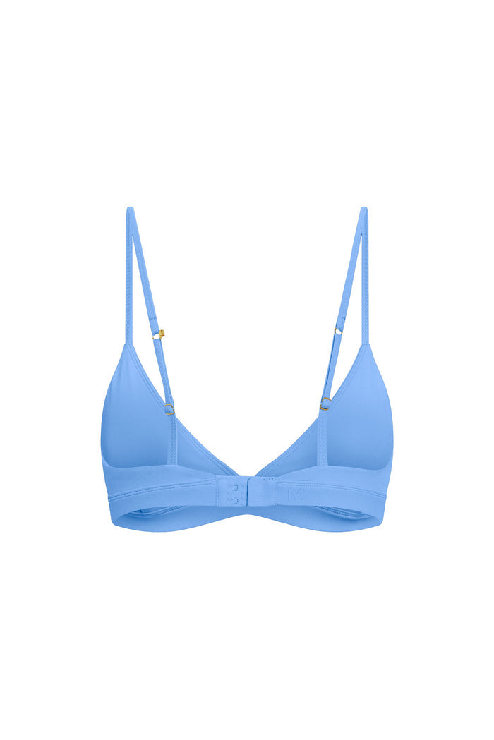 Flat lay of Brooklyn Bra in Azure showing molded triangle cups, adjustable straps, and hook-and-eye closure on white