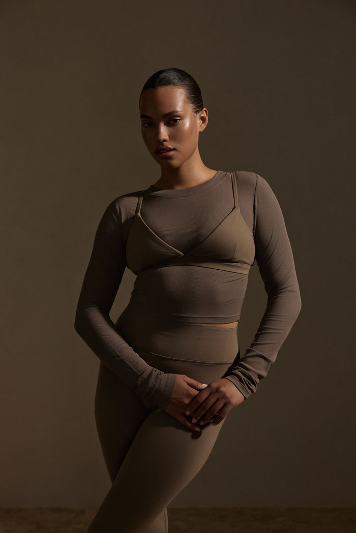 Three-quarter front of Brooklyn Bra in Stone Jersey, triangle bralette with thin straps on model against neutral background