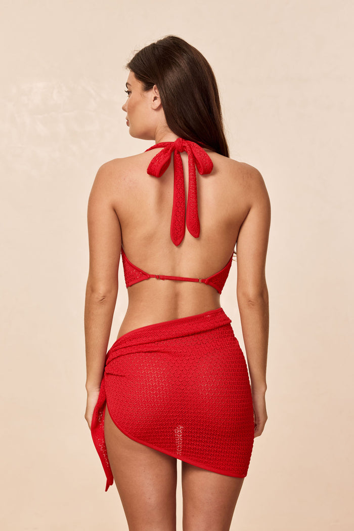 Back view of Bula cowl neck top in chili pepper lace crochet showing halter tie and low open back on neutral background