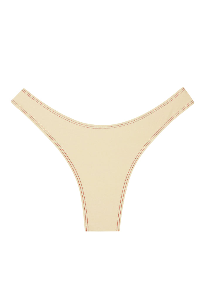 Front of Byron Bottom in Champagne Denim, mid-rise high-cut thong with contrast topstitching on white background