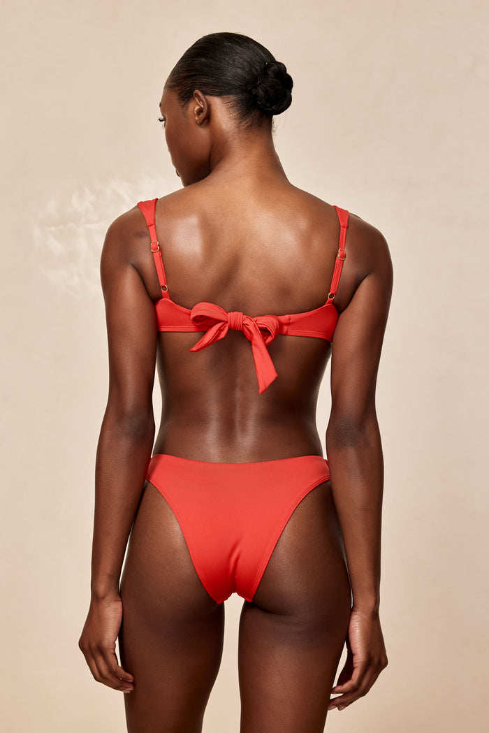 Rear view of Byron bottom in Chili Pepper showing cheeky coverage and smooth recycled nylon on beige background