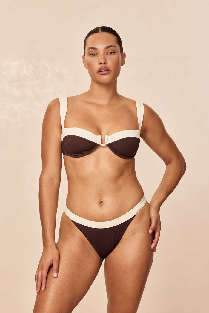 Front view of Cala Roja top in espresso and ivory on model, showing underwire cups and contrast wide straps on neutral background