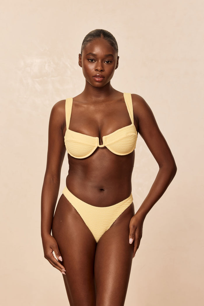 Front view of Cala Roja Top in Honey Crinkle with underwire balconette, wide straps and crinkle fabric on beige background