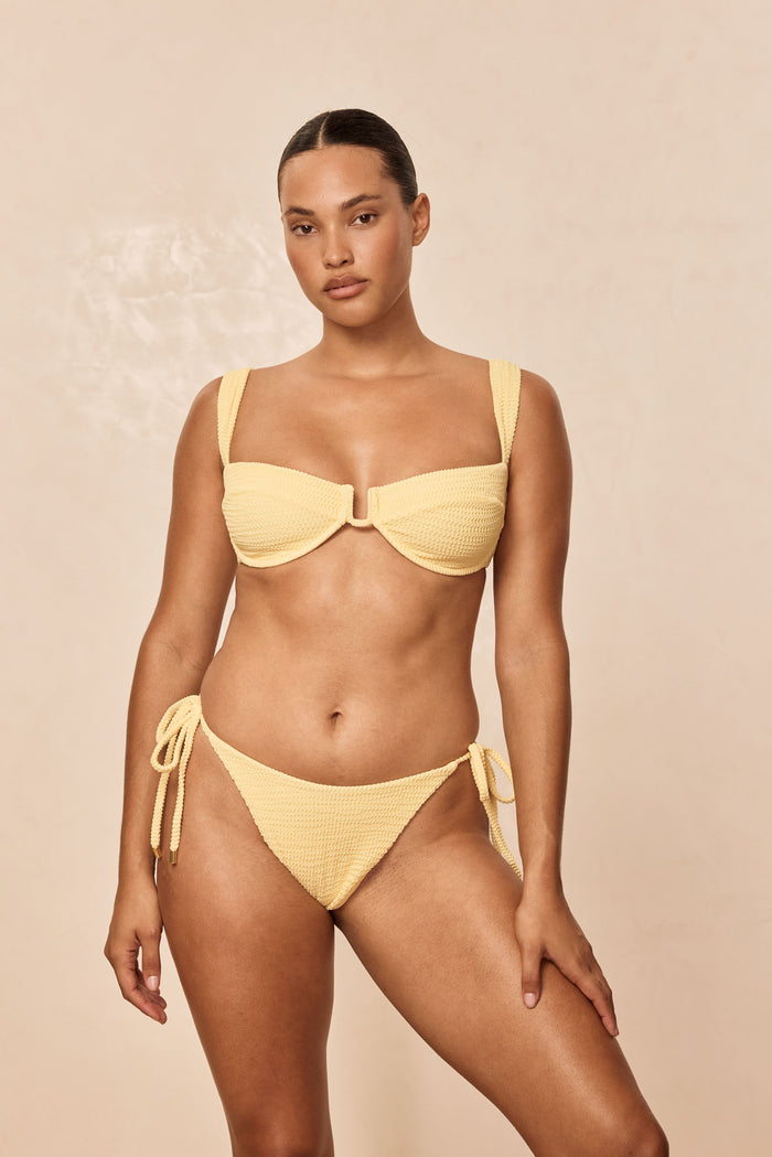 Front view of Cala Roja top in Honey Crinkle showcasing balconette U-center and wide straps on light beige background