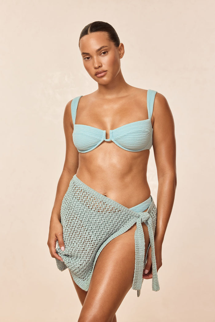 Front of Cala Roja top in Light Slate Crinkle — crinkle texture, underwire balconette with center U on beige background
