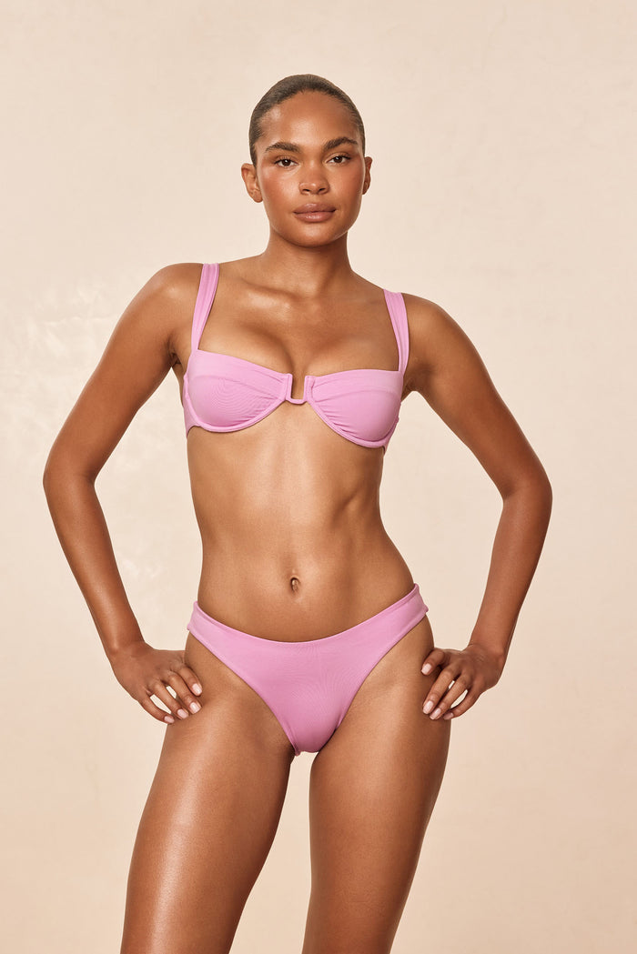 Front of Cala Roja top in Moonlight on model showing underwire cups, soft u wire center, wide straps, adjustable back tie