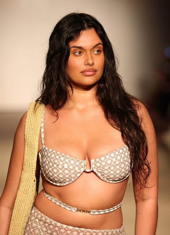 Front close-up of Cala Roja Top Tile Geo on model showing underwire balconette shape and tile-geo print on runway