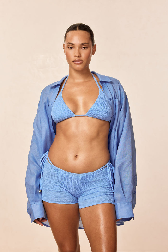 Front view of Cali Shorts in Azure Crinkle with low-rise fit, crinkle texture and side tie detail on model