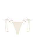 Front view of Cannes Bottom bikini bottom in Ivory showcasing adjustable side ties and gold ring details on a white background
