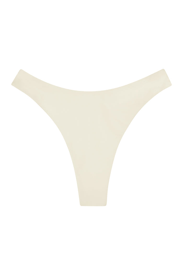 Flat lay of Capri Thong in Ivory showcasing seamless minimal-coverage design on white background