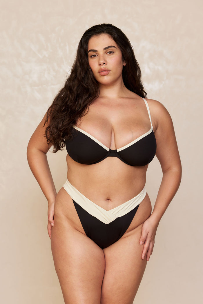 Front view of Marseille Bottom in Black/Ivory showing V-shaped contrast waistband and high-cut fit on a plus-size model