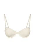Front view of Capri Top in ivory showcasing underwire molded cups and thin adjustable straps on beige background