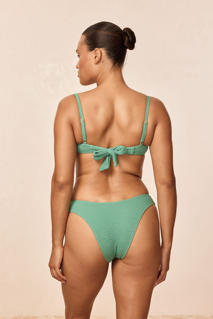 Rear view of Byron Bottom in Pond Crinkle showing medium coverage and textured crinkle fabric against a beige studio background