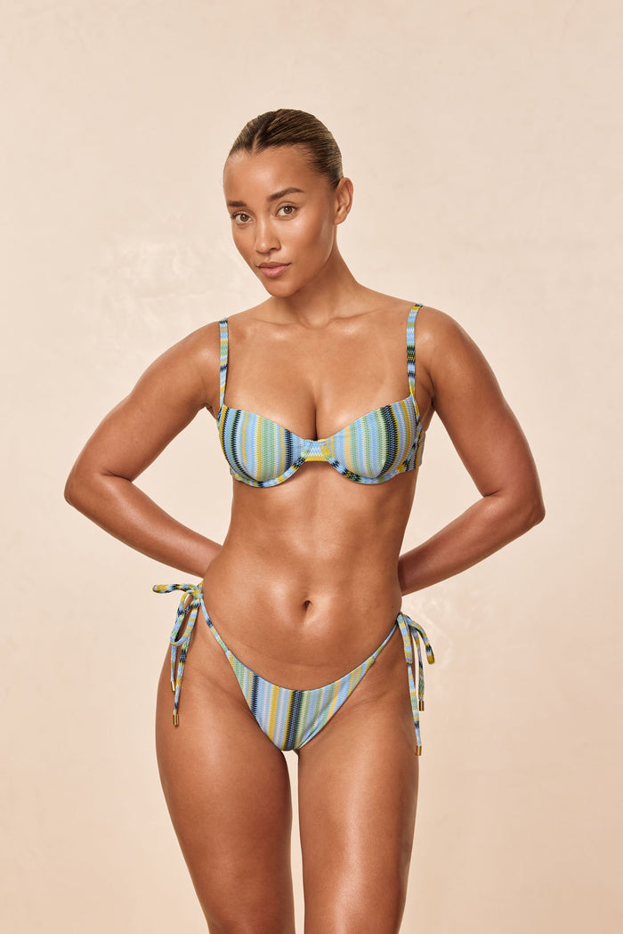 Front view of Le Marais bottom in Sardinia Stripe Azure showing low rise tie sides and blue green stripes on beige background