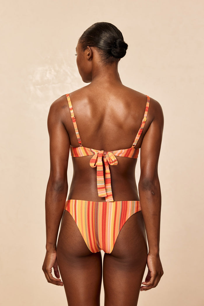 Rear view of Byron Bottom in Sardinia Stripe showing mid-rise fit and striped ribbed texture on neutral beige background