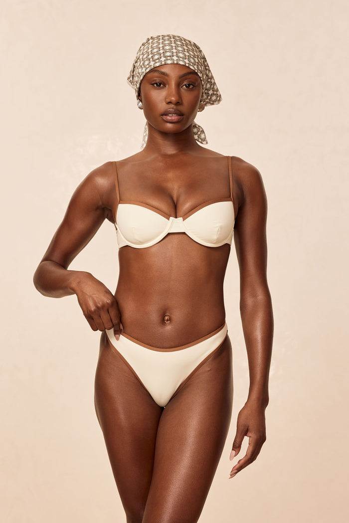 Front view of Capri Top Color Block (ivory/caramel) on model showing underwire support, caramel trim, and adjustable straps