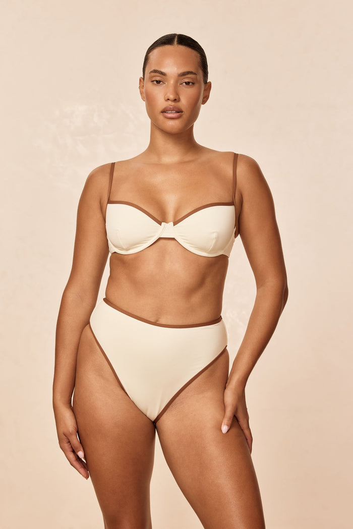 Front view of Capri Top Color Block in ivory with caramel trim showing underwire and adjustable straps on model