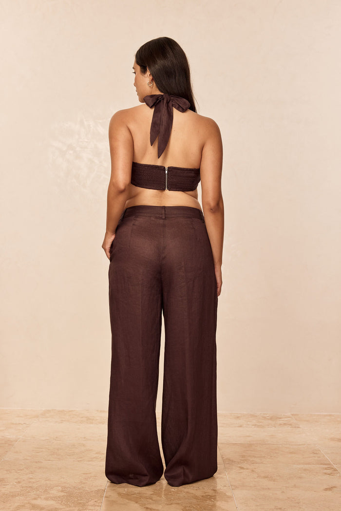 Rear view of Casablanca Pants in espresso linen showing high-rise waist and wide-leg fit on model against beige background