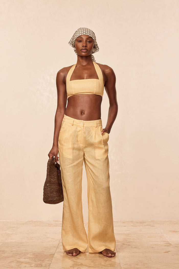Front view of Casablanca pants in raffia linen on model showing high-rise wide-leg with pleats and pockets