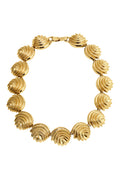 Gold statement collar necklace of textured scallop fan links connected by a box clasp