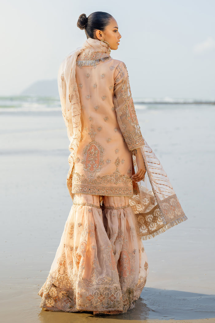 Side view of Chandni showcasing flowing gharara panels, shirt’s machine + hand embroidery along side seams and lavish dupatta drape.