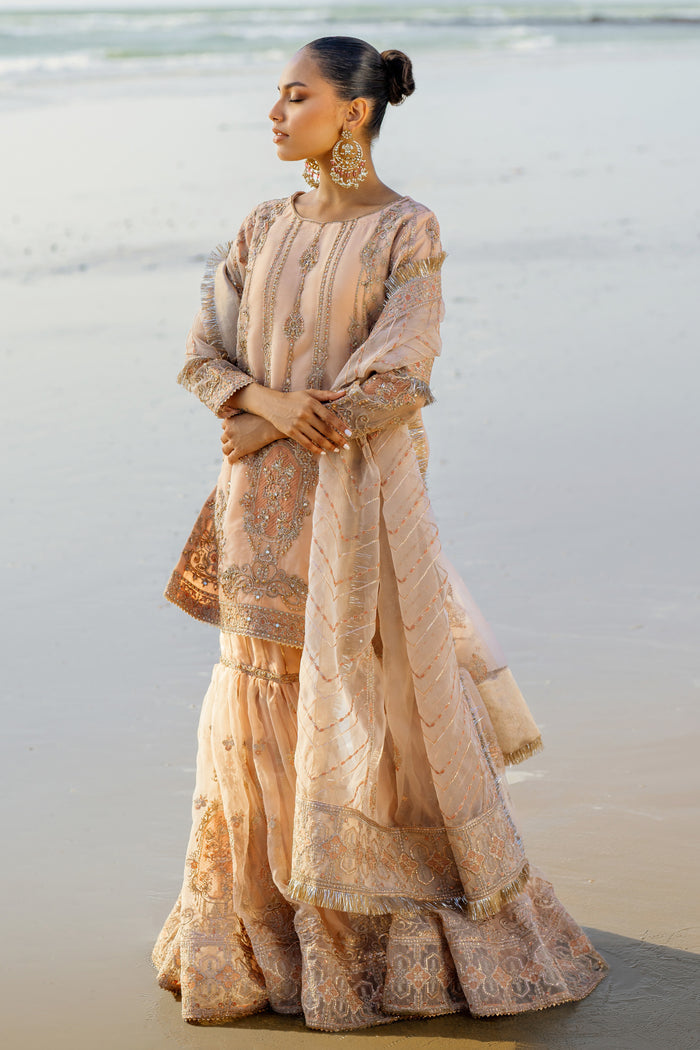 Detailed shot of Chandni sleeve cuff and shirt hem featuring embroidered border with sequin-dabka spread and kiran lace edging.