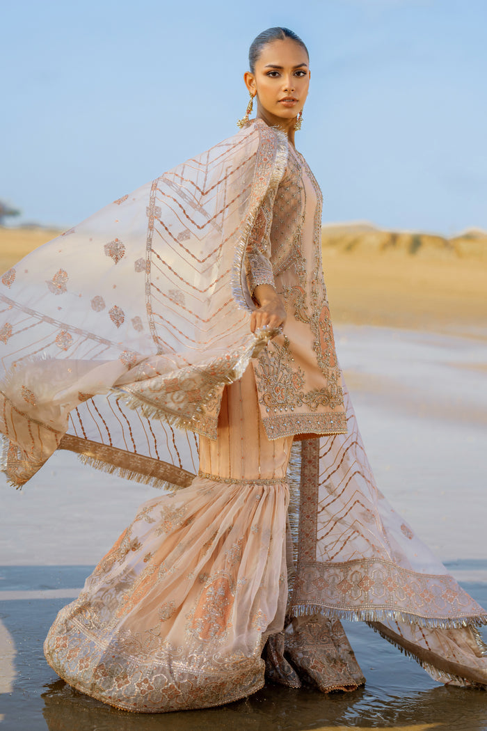 Model wearing full Naqshi Chandni 4PC set: embroidered shirt, flowing gharara & ornate dupatta styled for bridal elegance.