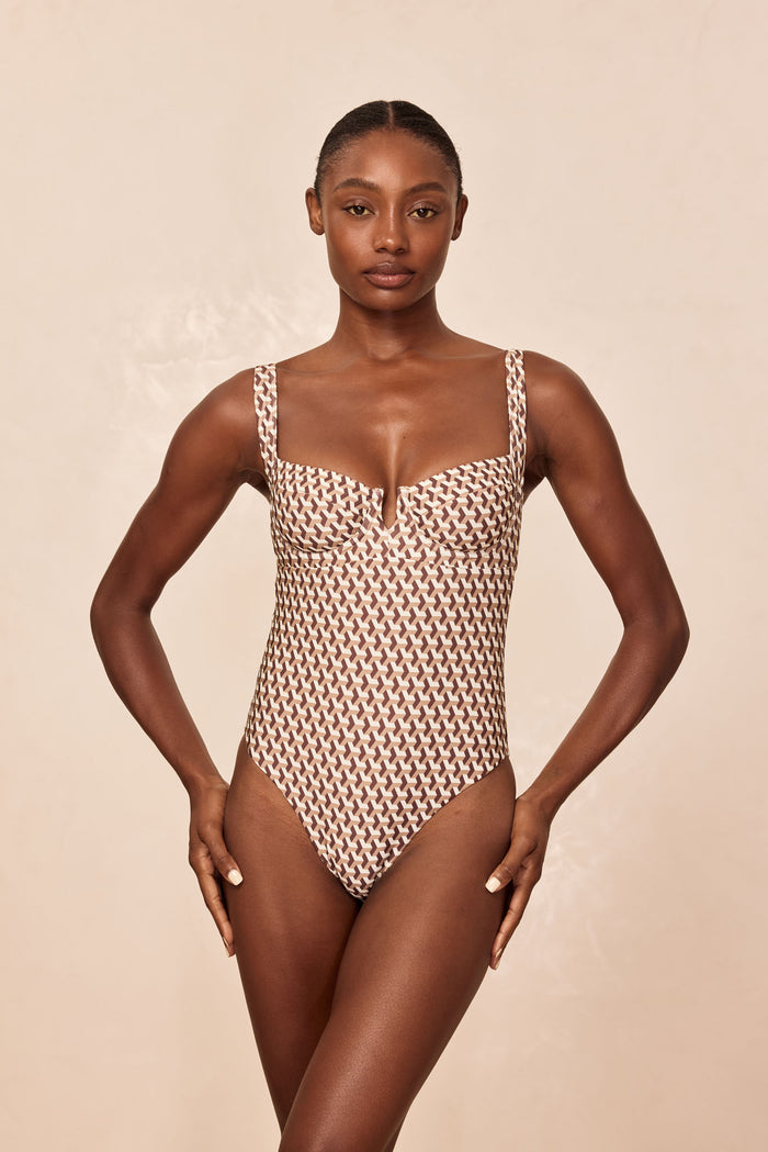 Front view of Clovelly One Piece Husk Geo showcasing underwire sweetheart neckline, square straps, and high-cut leg on neutral beige background