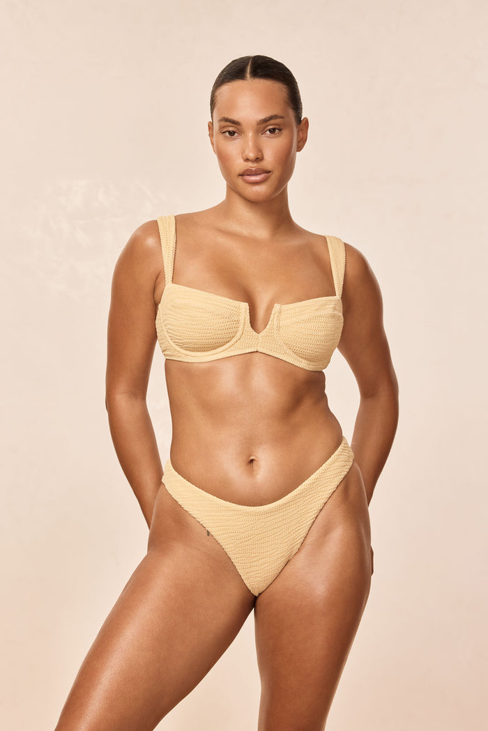 Front view of Clovelly Top in raffia crinkle showing underwire V-notch cups and textured fabric on neutral beige background