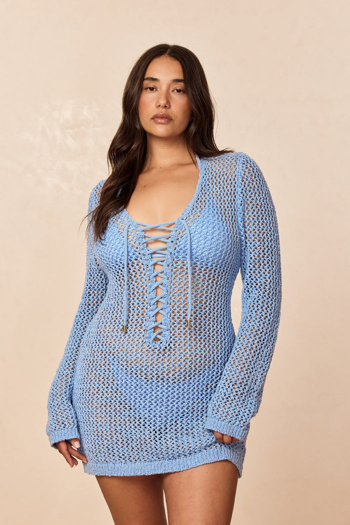 Front view of Corossol Mini Dress in Sky Petit Crochet showing lace up neckline, sheer crochet knit, and long sleeves