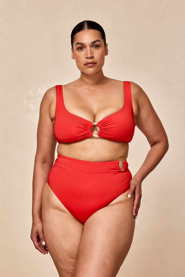 Front view of Costa Rica Bottom in Chili Pepper showcasing high-waist coverage and gold ring hip detail on neutral background