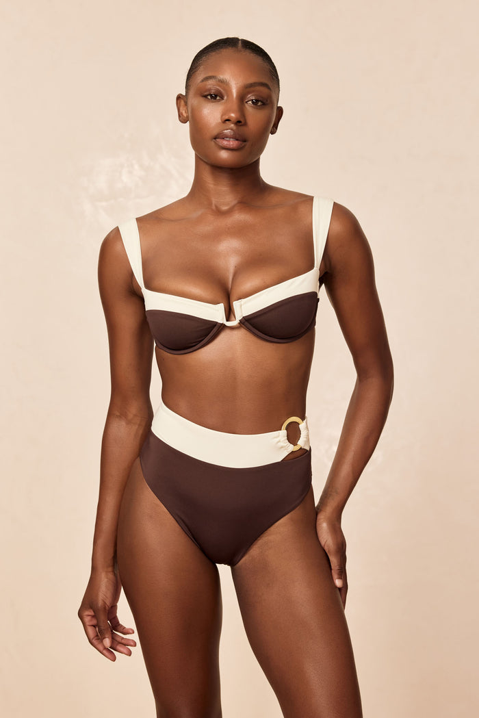 Front view of Costa Rica Bottom in espresso and ivory high-waisted full coverage with gold ring on beige background