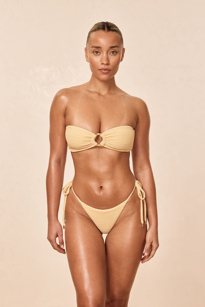 Front view of Costa Rica Top in Raffia Crinkle, strapless bandeau with center ring and textured crinkle fabric on a beige background
