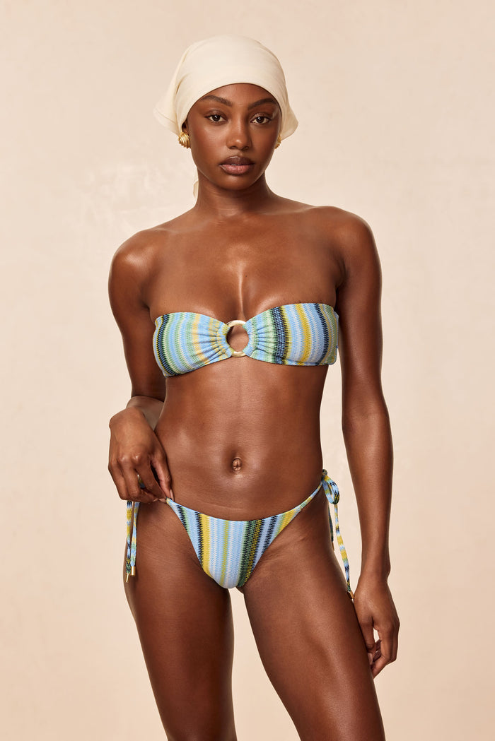 Front of Le Marais tie-side bottom in Sardinia Stripe Azure on model showing low-rise fit and multicolor stripes