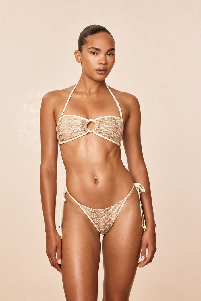 Front view of Costa Rica Top in Porto Cervo Gold, strapless bandeau with gold center ring and color-block fabric on beige background