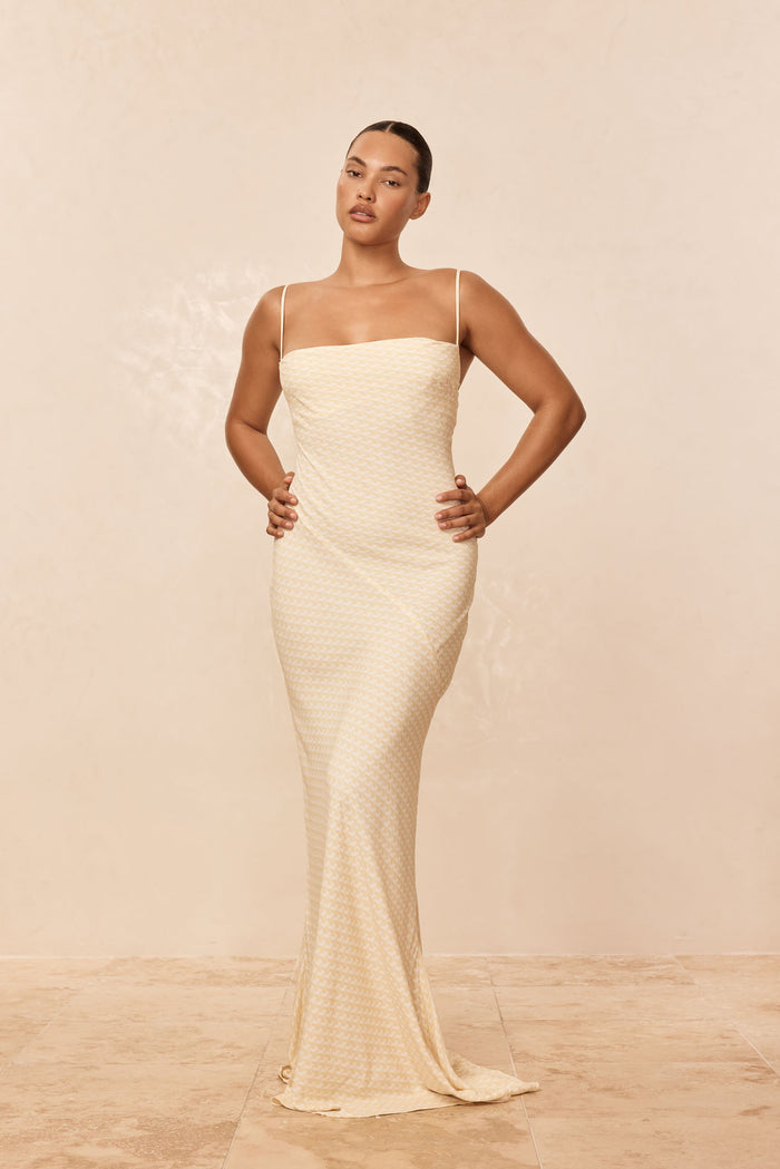 Front view of Cote D’azur Dress in Ivory Geo, fitted strap dress with straight neckline and column shape on beige background