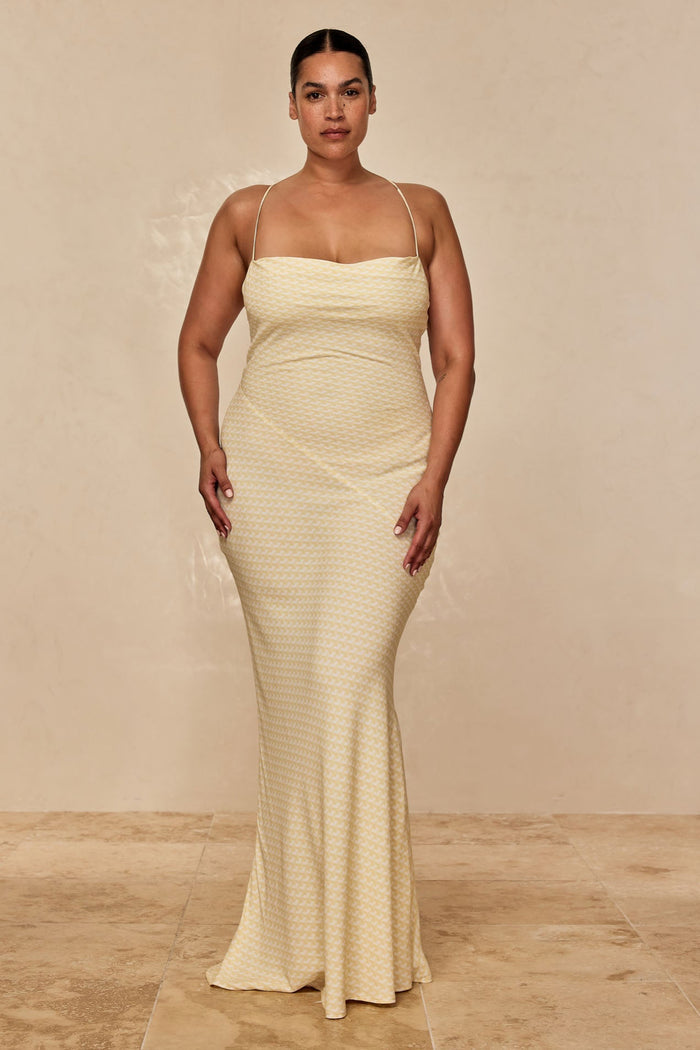 Front view of Cote D’azur Dress in Ivory Geo showcasing straight neckline, thin spaghetti straps and fitted column silhouette on beige backdrop