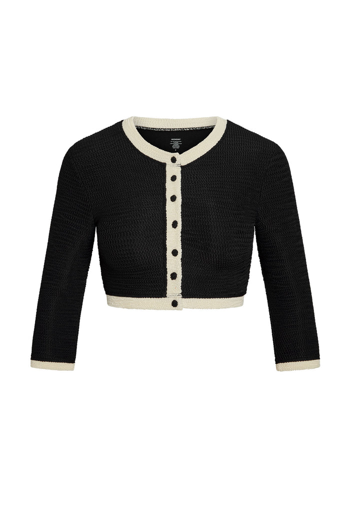 Front view of Crete Swim Cardi in Black/Ivory Crinkle showcasing cropped knit silhouette, ivory contrast trim and front buttons on white background