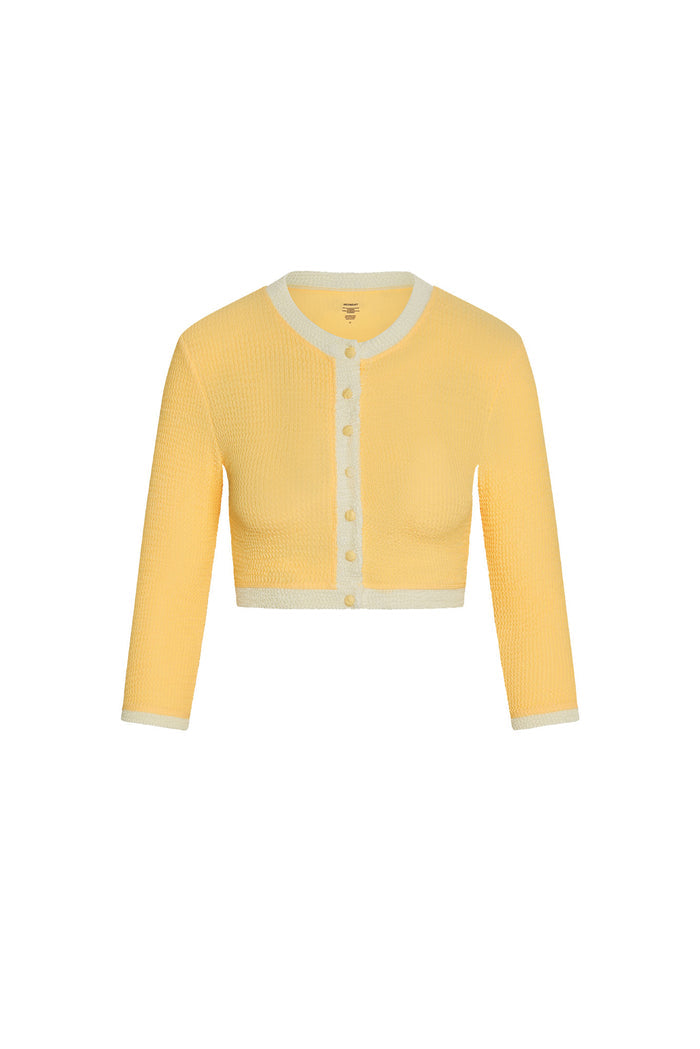 Front view of Crete Swim Cardigan in honey crinkle showing cropped fit, 3/4 sleeves, button front and cream trim on white
