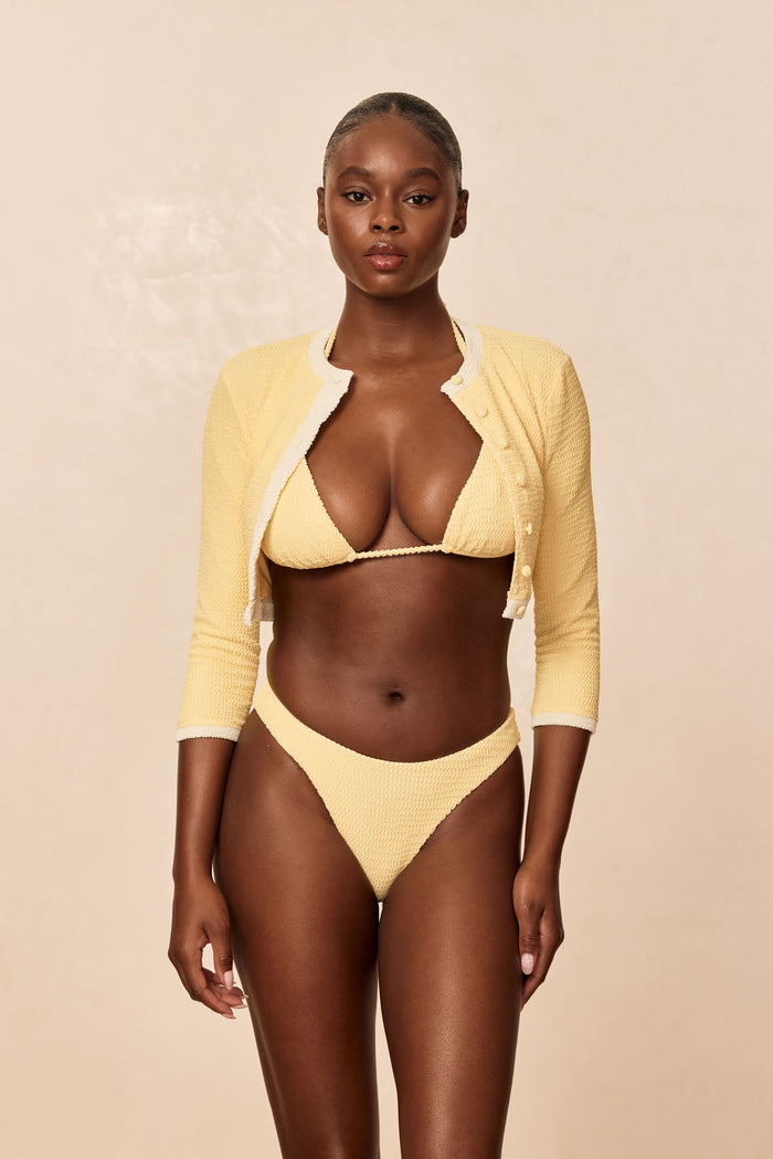 Front view of Crete Swim Cardigan in Honey Crinkle on model, cropped button-up with 3/4 sleeves and contrast trim