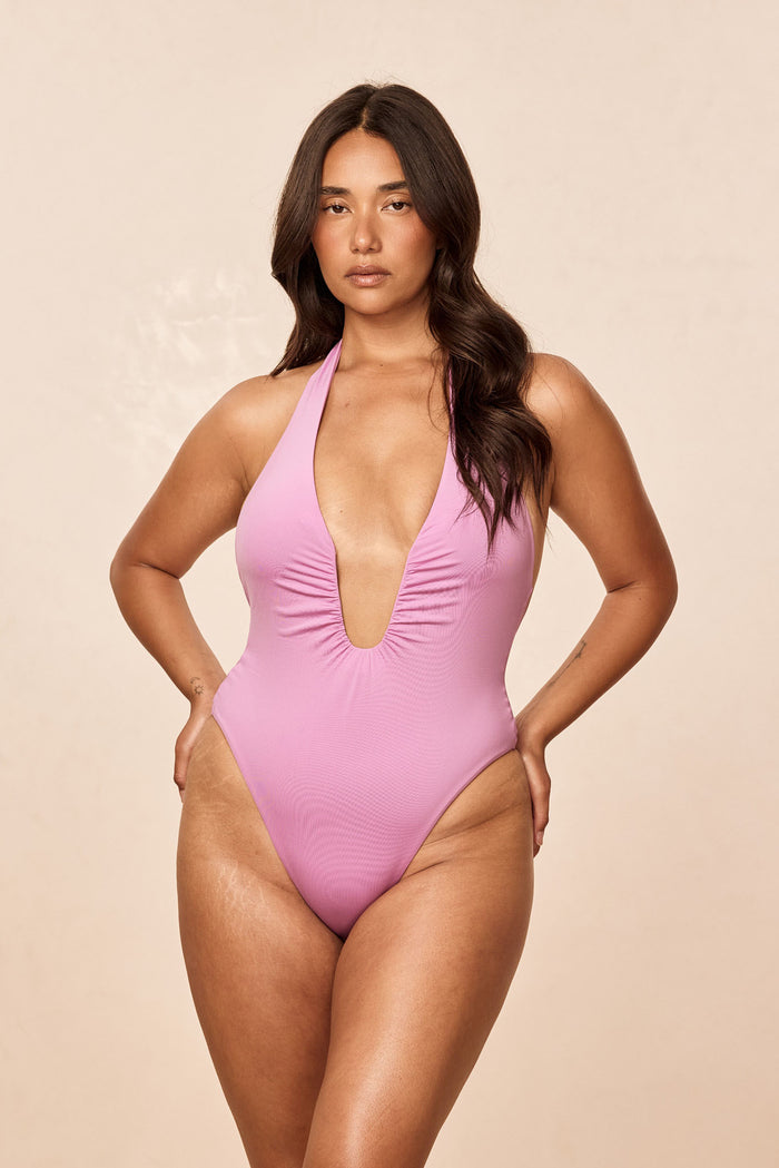 Front view of Croatia One Piece in Moonlight with halter plunge, U-wire detail and high leg on a beige background