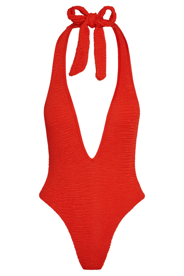 Front view of Cyprus one-piece in Chili Pepper crinkle with deep V halter, tie straps, and textured fabric on white background